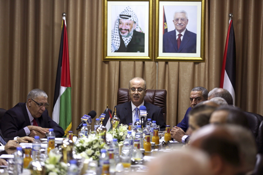 Palestinian Prime Minister Rami Hamdallah, center, chairs a reconciliation government cabinet meeting in Gaza City on Tuesday. The Palestinian prime minister has held the first government meeting in Gaza as part of a major reconciliation effort to end the 10-year rift between Fatah and the militant Hamas group.