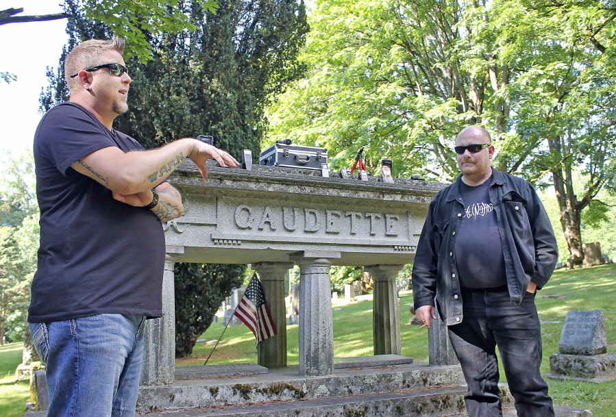 Washington Abnormal Research Network investigators Travis Fletcher, left, and Brian Lee explain June 28, how they use various devices to listen and watch for spirits or ghosts at Bay View Cemetery in Bellingham.