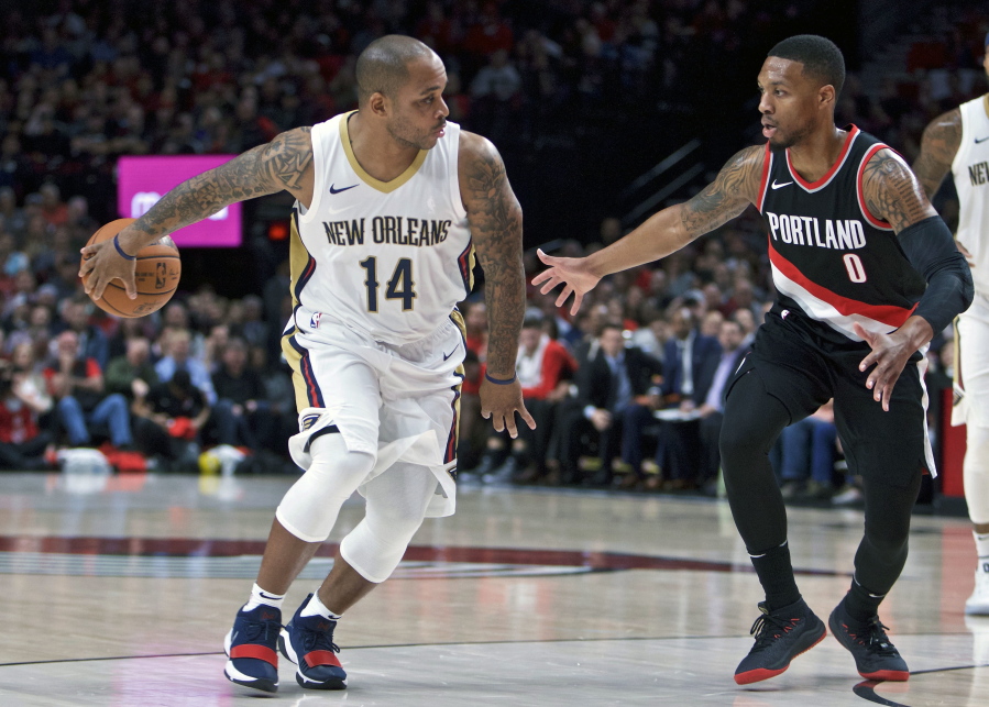 New Orleans Pelicans guard Jameer Nelson, left, passes the ball away from Portland Trail Blazers guard Damian Lillard, right, during the first half of an NBA basketball game in Portland, Ore., Tuesday, Oct. 24, 2017.