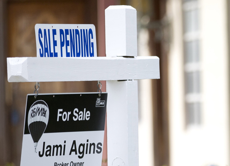 FILE - In this Thursday, Jan. 8, 2015, file photo, a “Sale Pending” sign sits atop a realty sign outside a home for sale in Surfside, Fla. The National Association of Realtors releases its September 2017 report on pending home sales on Thursday, Oct. 26, 2017.