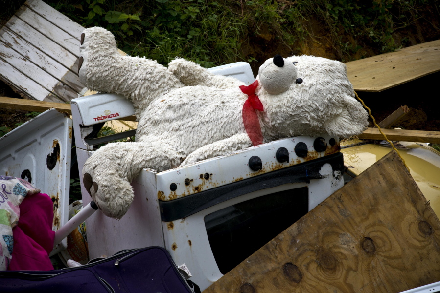 A teddy bear sits on the the belongings of the Sortre family, their home destroyed by Hurricane Maria, in the San Lorenzo neighborhood of Morovis, Puerto Rico, Saturday, Sept. 30, 2017. FEMA chief Brock Long said the agency has worked to fix roads, establish emergency power and deliver fuel to hospitals. He said telecommunications are available to about one-third of the island.