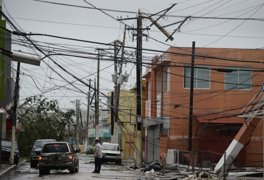 FILE - In this Wednesday, Sept. 20, 2017 file photo, power lines are down after the impact of Hurricane Maria, which hit the eastern region of the island in Humacao, Puerto Rico. In the wake of Hurricane Maria, Facebook pledged to send a “connectivity team” to help restore communications in ravaged Puerto Rico. It’s just one of several tech companies - among them Tesla, Google, Cisco, Microsoft and a range of startups - with their own disaster response proposals, most aimed at getting phone and internet service up and running.
