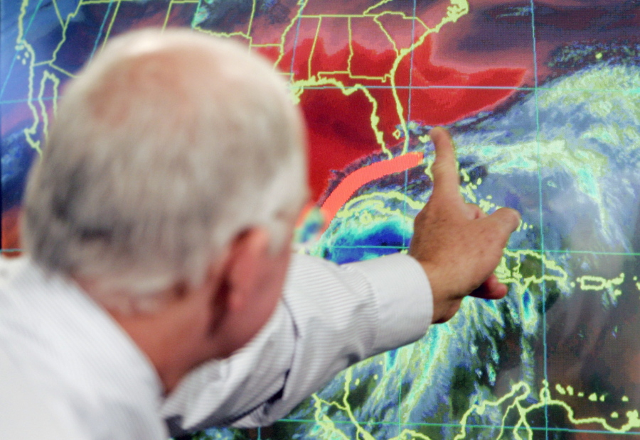 FILE - In this Oct. 19, 2005 file photo, Max Mayfield, the former director of the hurricane center (now retired), draws a line showing one of the possible trajectories of Hurricane Wilma in Miami. It’s not just this year. The monster hurricanes Harvey, Irma, Maria, Jose and now Lee that have raged across the Atlantic are contributing to what appears to be the most active period for major storms on record.