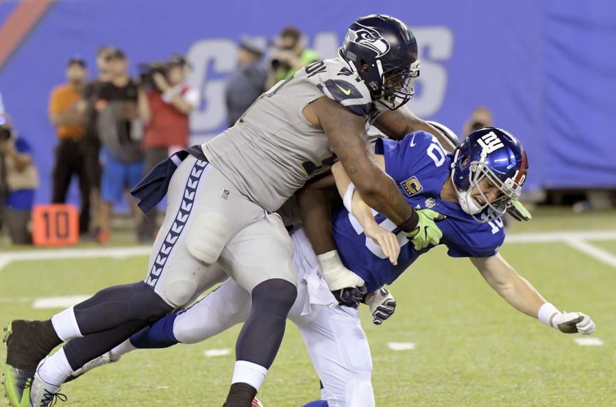 Seattle Seahawks’ Sheldon Richardson, left, tackles New York Giants quarterback Eli Manning during the second half of an NFL football game, Sunday, Oct. 22, 2017, in East Rutherford, N.J.