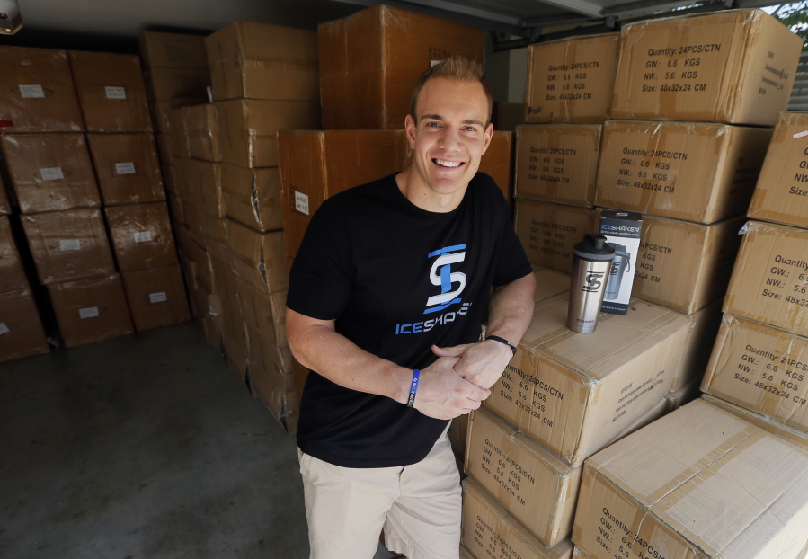 In this Thursday, Aug. 31, 2017, photo, former NFL fullback Chris Gronkowski poses with boxes of his product, Ice Shaker, stacked in his garage, in Colleyville, Texas. For business advice, Gronkowski turned to his father, who’d had his own company for 26 years. He helped shore up Gronkowski’s confidence and also gave him some realistic advice.