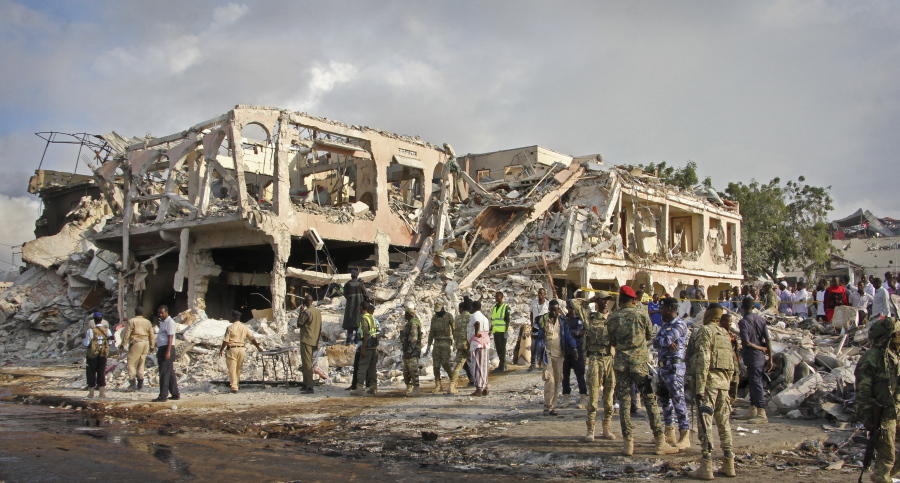 Somali security forces and others gather and search for bodies near destroyed buildings at the scene of Saturday’s blast, in Mogadishu, Somalia Sunday. The death toll from the huge truck bomb blast in Somalia’s capital rose to over 50 Sunday, with more than 60 others injured, as hospitals struggled to cope with the high number of casualties, security and medical sources said.