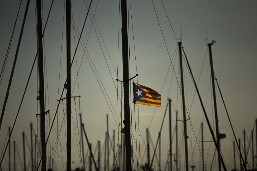 A Catalonia independence flag waves Tuesday on the mast of a boat at the port of Vilanova i La Geltru, Spain.