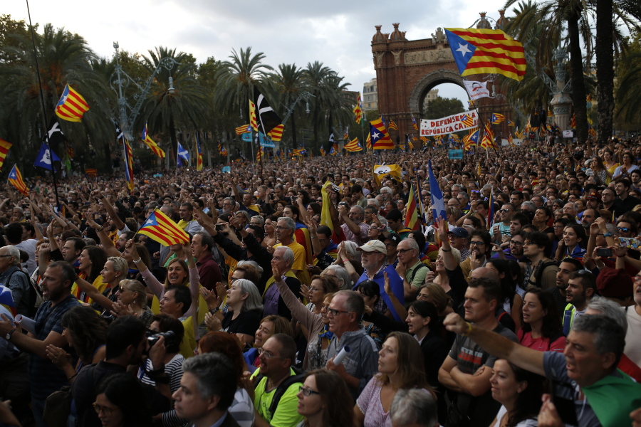 Pro-independence supporters take part in a rally in Barcelona, Spain, Tuesday, Oct. 10, 2017. Catalan President Carles Puigdemont said during his speech in the parliament that the region remained committed to independence but said it should follow dialogue with the government in Madrid.