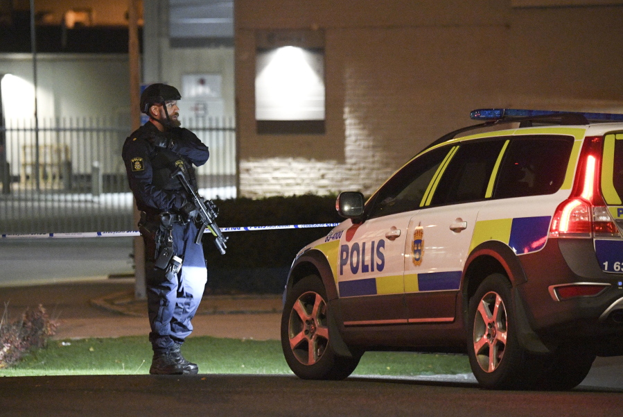 A police officer stands guard outside a cordoned off area surrounding a police station in Helsingborg, Sweden, on Wednesday. Swedish authorities said the explosion caused significant damage to the building. There have been no injuries and nobody has been arrested.