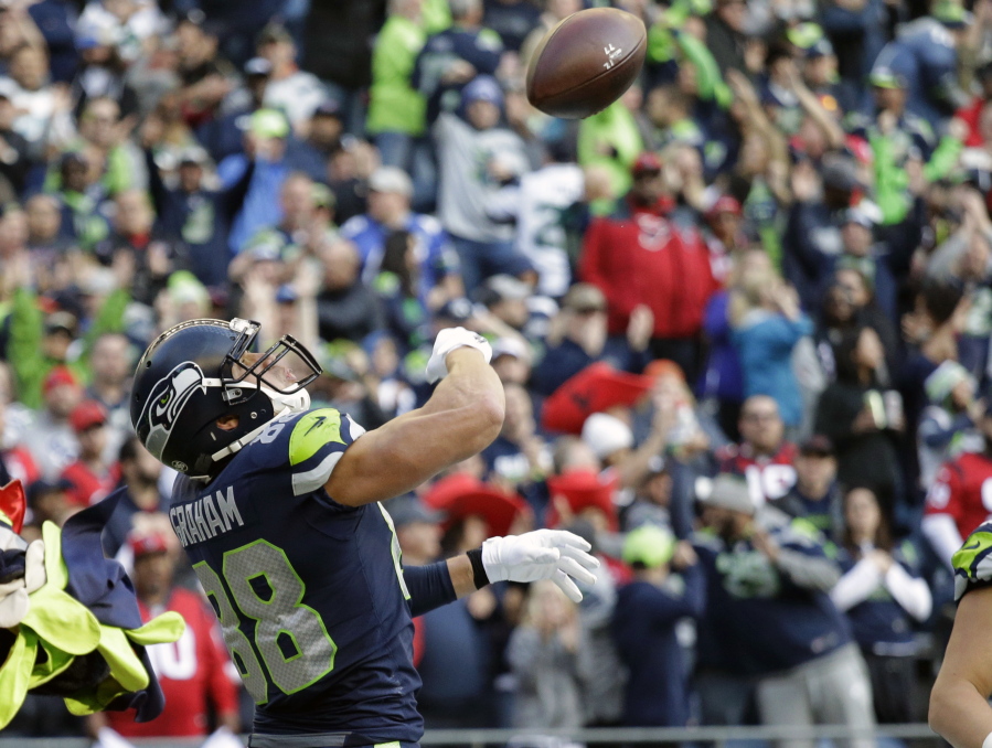 Seattle Seahawks tight end Jimmy Graham tosses the football after scoring a touchdown in the second half against the Houston Texans during an NFL football game, Sunday, Oct. 29, 2017, in Seattle.