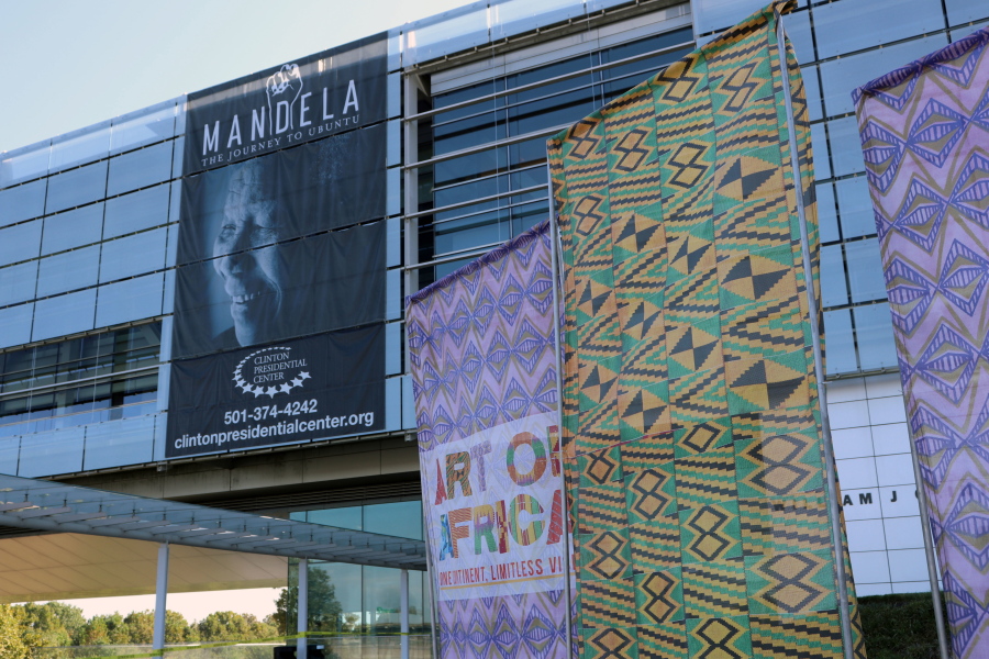 In this Oct. 10, 2017 photo, fabric banners stand in front of the Clinton Presidential Center in Little Rock, Ark. The Clinton Library is presenting “Mandela: The Journey to Ubuntu” and “Art of Africa: One Continent, Limitless Vision” until February. (AP Photo/Kelly P.