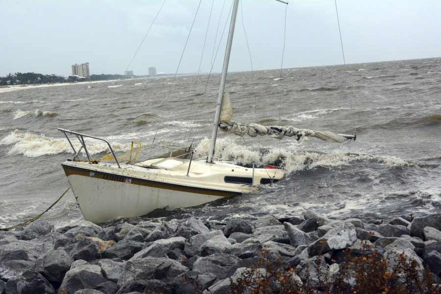 An abandoned boat takes on water Saturday near Biloxi, Miss., as the outer bands of Hurricane Nate begin to batter the shore.