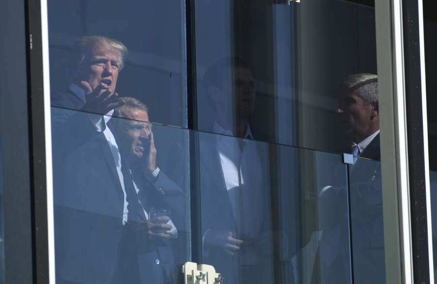 President Donald Trump watches the Presidents Cup golf tournament at the Liberty National Golf Course in Jersey City, N.J., Sunday. The President of the United States is the Honorary Presidents Cup Chairman.
