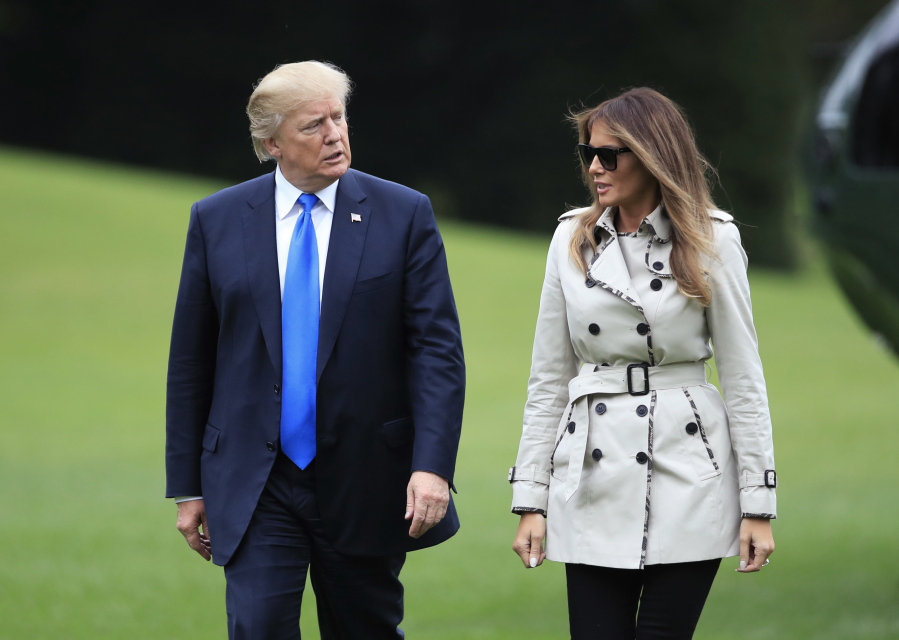 President Donald Trump and first lady Melania Trump walk on the South Lawn of the White House in Washington on Friday upon arrival from a visit to the United States Secret Service James J. Rowley Training Center in Beltsville, Md.