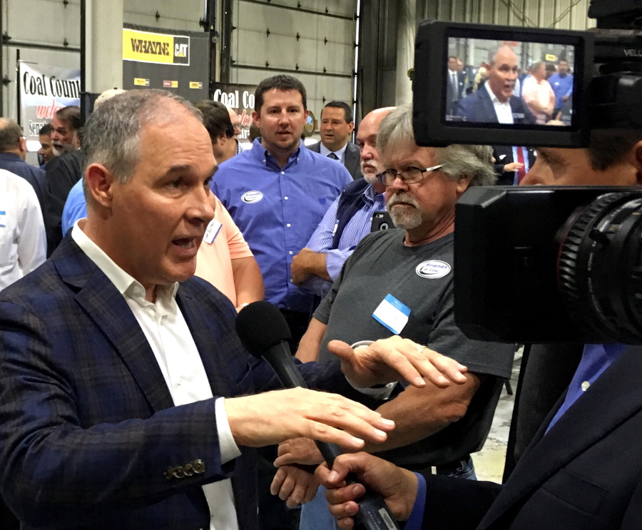 EPA Administrator Scott Pruitt, talks to a reporter after speaking at Whayne Supply in Hazard, Ky, Monday. Pruitt says the Trump administration will abandon the Obama-era clean power plan aimed at reducing global warming.