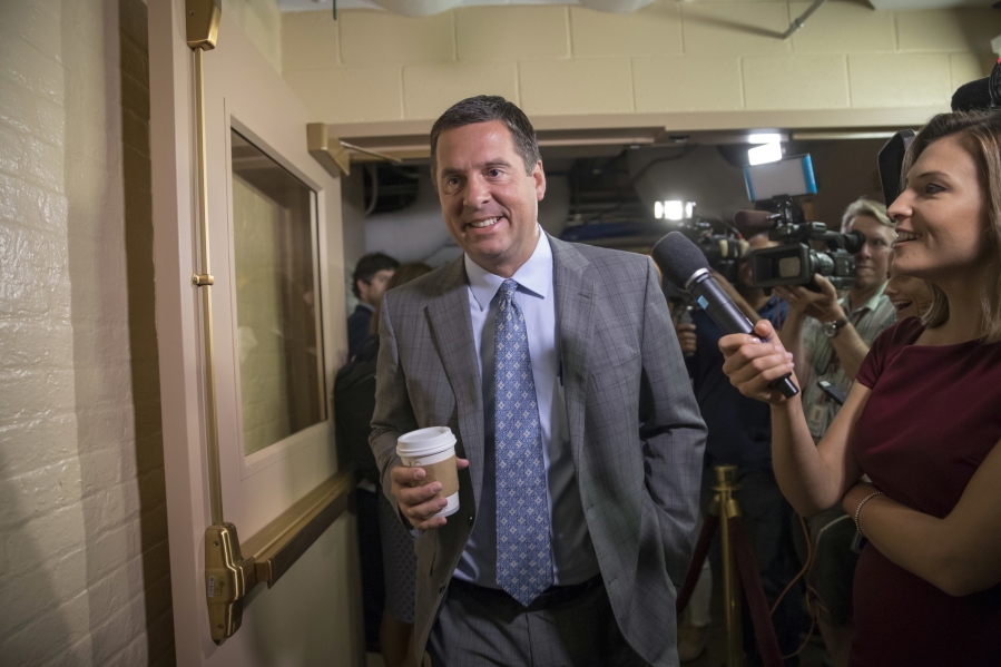 FILE - In this July 28, 2017, file photo, House Intelligence Committee Chairman Rep. Devin Nunes, R-Calif., walks on Capitol Hill in Washington. A political research firm behind a dossier of allegations about President Donald Trump’s connections to Russia has been subpoenaed by the House intelligence committee. Joshua Levy, a lawyer for Fusion GPS, said in a statement Ton Oct. 10 that the subpoenas were signed by Nunes even though the Republican committee chairman stepped aside months ago from leading the panel’s Russia probe. (AP Photo/J.
