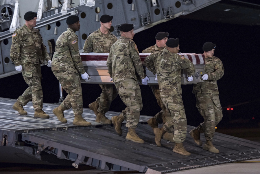 A carry team of soldiers from the 3d U.S. Infantry Regiment (The Old Guard), carry the transfer case during a casualty return for Staff Sgt. Dustin M. Wright, of Lyons, Ga., at Dover Air Force Base, Del., on Oct. 5. U.S. and Niger forces were leaving a meeting with tribal leaders when they were ambushed on Oct. 4 and Wright and three other soldiers were killed. There were about a dozen U.S. troops and a company of Niger forces, for a total of about 40 service members in the joint mission. (Pfc. Lane Hiser/U.S.