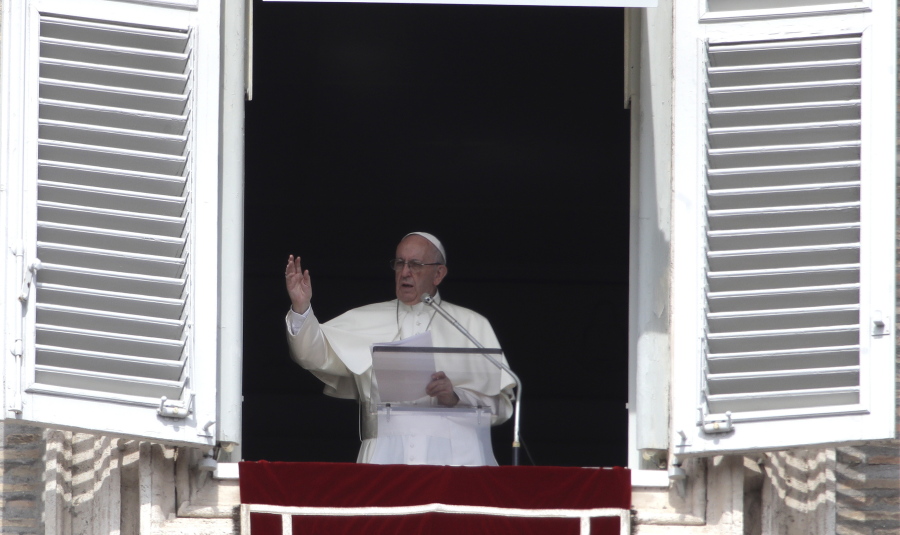 Pope Francis delivers his blessing Sept. 24 during the Angelus noon prayer from the window of his studio overlooking St. Peter’s Square, at the Vatican.