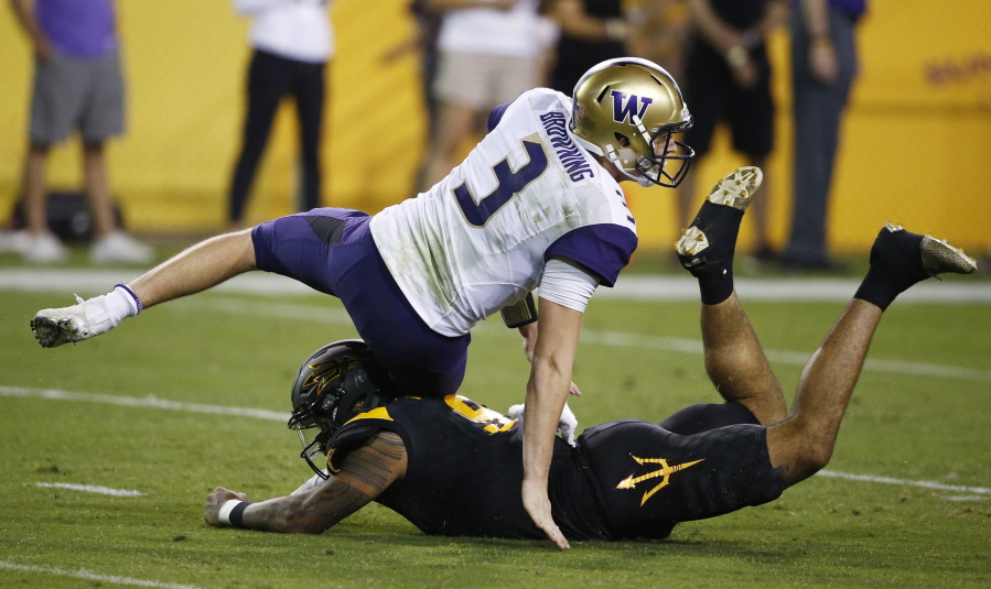 Washington quarterback Jake Browning (3) gets taken down by Arizona State’s Jay Jay Wilson (9) during the first half of an NCAA college football game, Saturday, Oct. 14, 2017, in Tempe, Ariz. (AP Photo/Ross D.