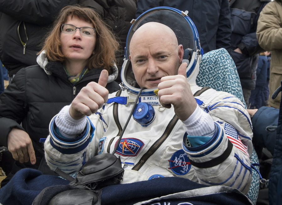 FILE - In this Wednesday, March 2, 2016 photo provided by NASA, International Space Station (ISS) crew member Scott Kelly of the U.S. reacts after landing near the town of Dzhezkazgan, Kazakhstan. In his new autobiography, the retired astronaut writes about his U.S. record-breaking year in space and the challenging life events that got him there.