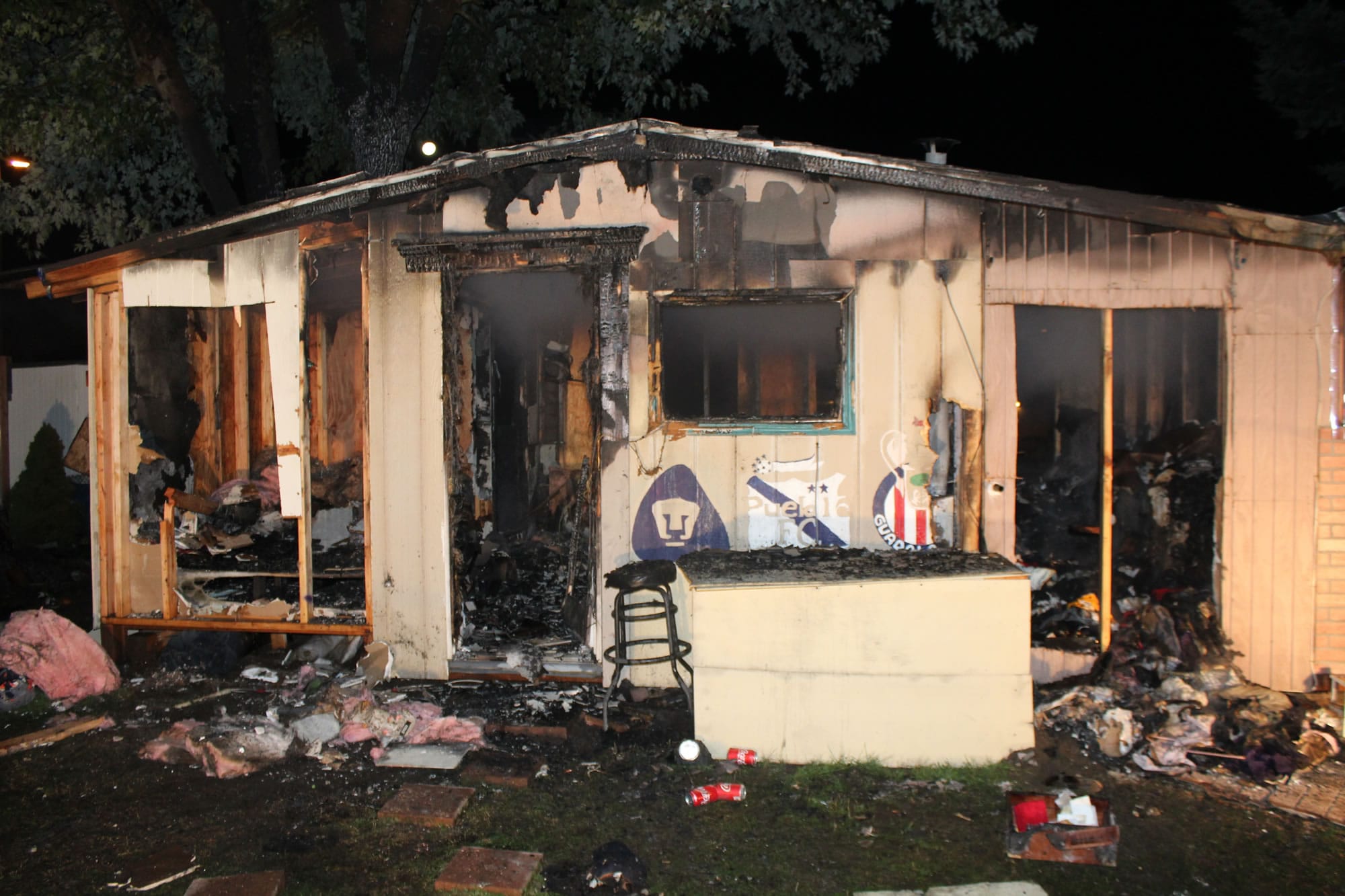 A candle left unattended caused significant damage to an outbuilding, which was being used as a residence.