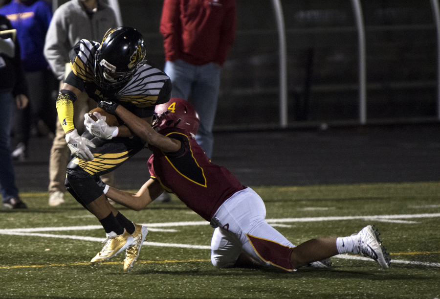 Quadrese Teague (4) of Hudson’s Bay pulls through to the end zone for a touchdown as Prairie’s Izaiah Ward (4) tried to take him down during the 3A GSHL tiebreaker at Doc Harris stadium on Monday night, Oct. 30, 2017. Hudson’s Bay won the tiebreaker 6-3.