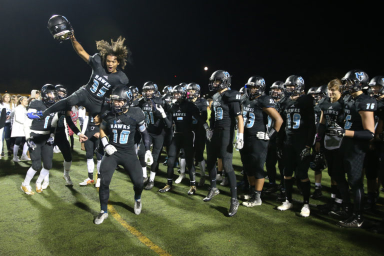 Hockinson Hawks Tony Richardson (35) and Kyle Brabec (10) celebrate with teammates after they beat the Aberdeen Bobcats, 49-8, in the 2A district football playoffs at Battle Ground District Stadium on Friday, Nov. 4, 2017. (Randy L.