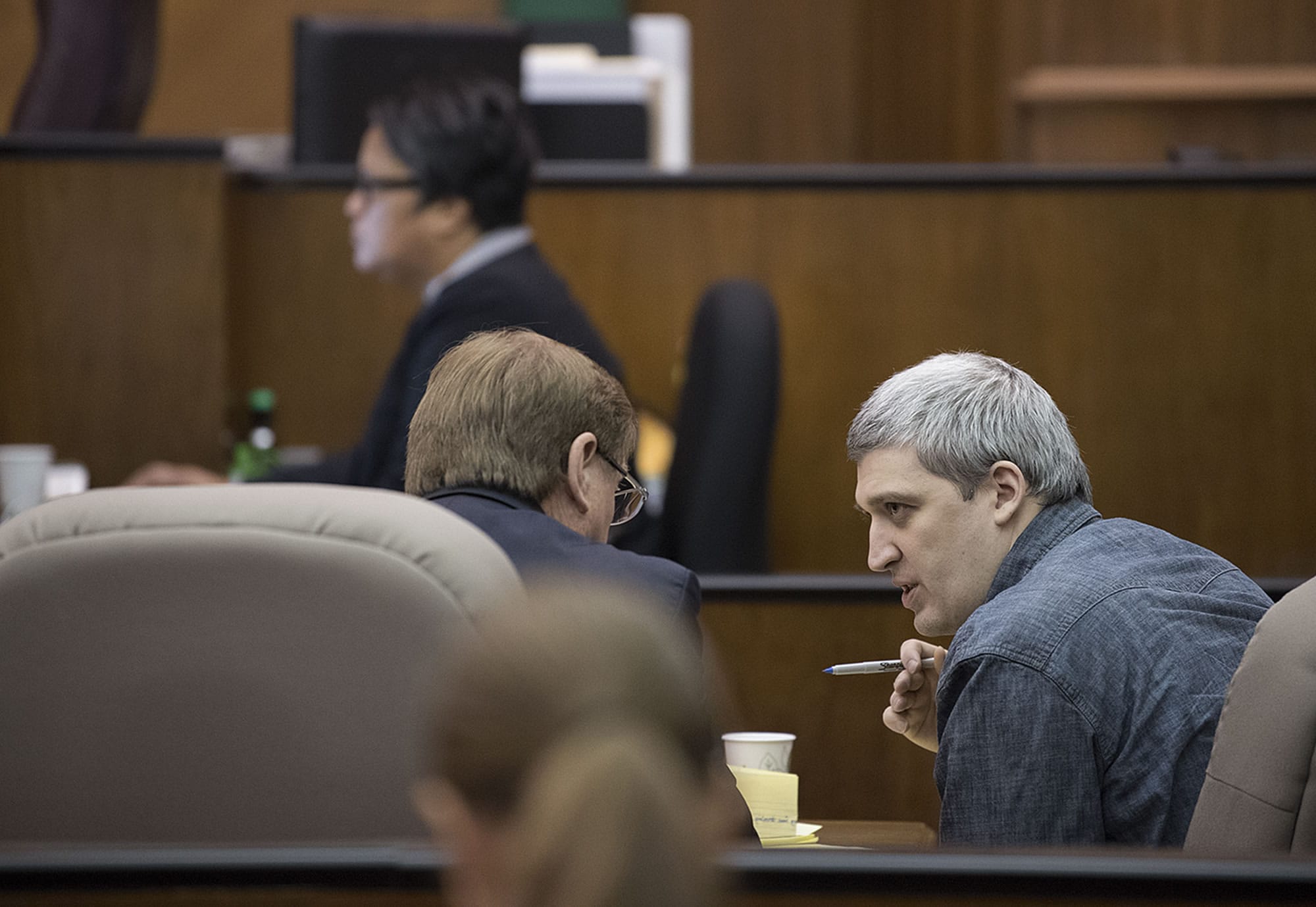 Brent Luyster, right, waits for opening statements to begin in his triple aggravated murder trial in Clark County Superior Court on Nov. 1.