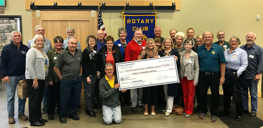 Battle Ground: Members of the Lewis River Rotary present a check for $20,000 to Ashley Homer, center, director of the Red Sweater Project, a nonprofit which looks to help kids in Tanzania continue education after elementary school.