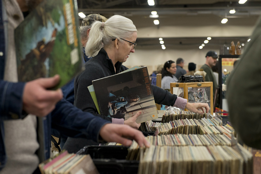 Crystine Jividen of Vancouver scores a copy of Carole King’s classic 1971 album, “Tapestry,” while browsing bins of vinyl at the NW’s Largest Garage Sale & Vintage Sale at the Clark County Event Center at the Fairgrounds on Saturday.
