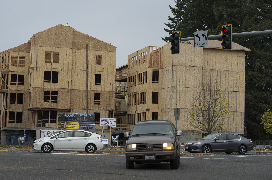 Traffic in Salmon Creek travels past the new 134th Street Lofts on a recent morning. The 124-unit complex is expected to open in April.