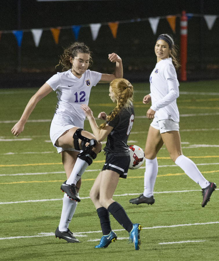 Columbia River’s Katie Colson (12) saves the ball from Clarkston’s Taylen Wohl (6) during the first round of the 2A girls soccer state playoffs against Clarkston at Kiggins Bowl in Vancouver, Wednesday November 8, 2017.
