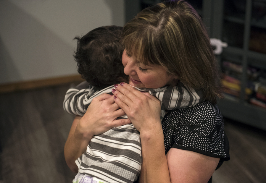 Sheryl Herd hugs her son Karter, 2, as they play in the living room after breakfast Wednesday morning at their home in northeast Vancouver. Karter’s adoption was finalized earlier this month. “I just wish I could encourage more people to do it,” Herd said.