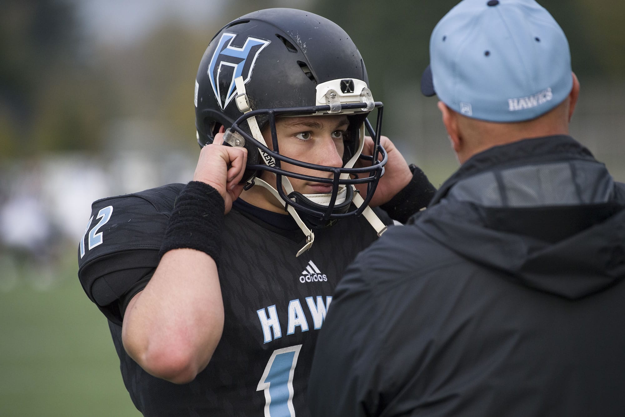 Hockinson’s Cannon Racanelli (12) talks to a coach after scoring a touchdown during the class 2A state playoffs against Pullman at Battle Ground District Stadium, Friday November 10, 2017.