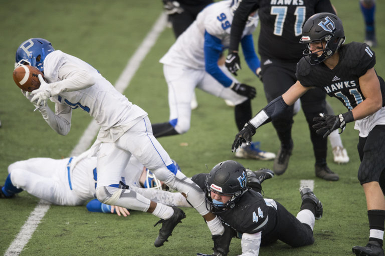 Hockinson’s Colton Wheeler (44) and Sawyer Racanelli (11) take down Pullman’s Isaiah Strong (11) during the class 2A state playoffs at Battle Ground District Stadium, Friday November 10, 2017.