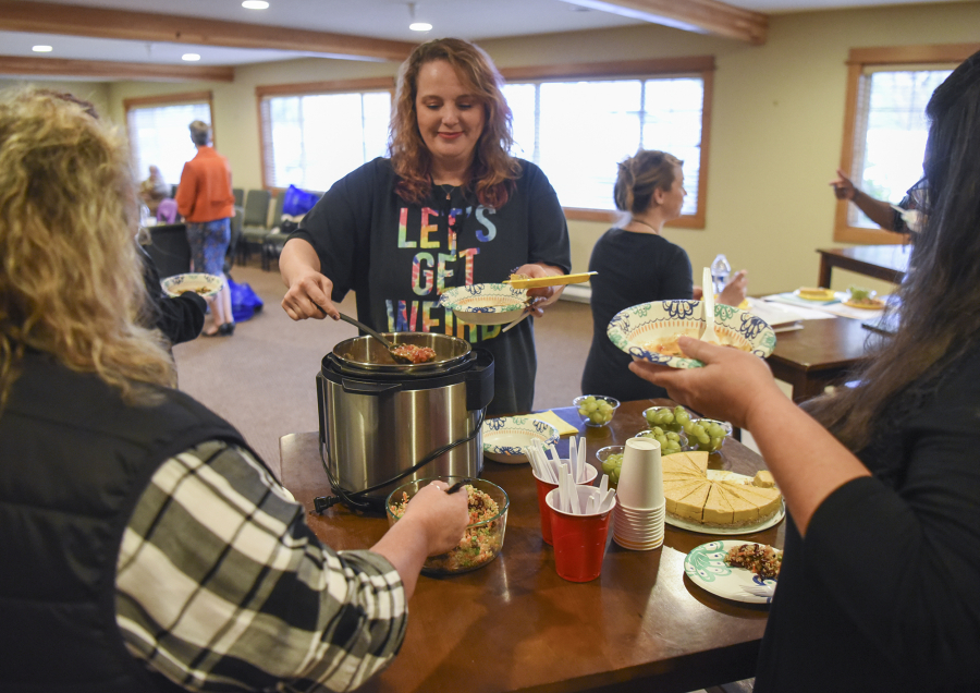Shannon Livingood of Vancouver, center, dishes herself a bowl of soup during the final meeting of the Taking Back My Life pain management group Tuesday at Battle Ground HealthCare in Meadow Glade. Livingood enrolled in the nine-week program to learn how to manage her chronic pain without medication.
