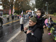 Miguel Vizcaino of Vancouver and his daughter Vanessa, 3, watch the annual Lough Legacy Veterans Parade at Fort Vancouver on Saturday. Miguel’s brother, Jose, served in the U.S. Marine Corps.