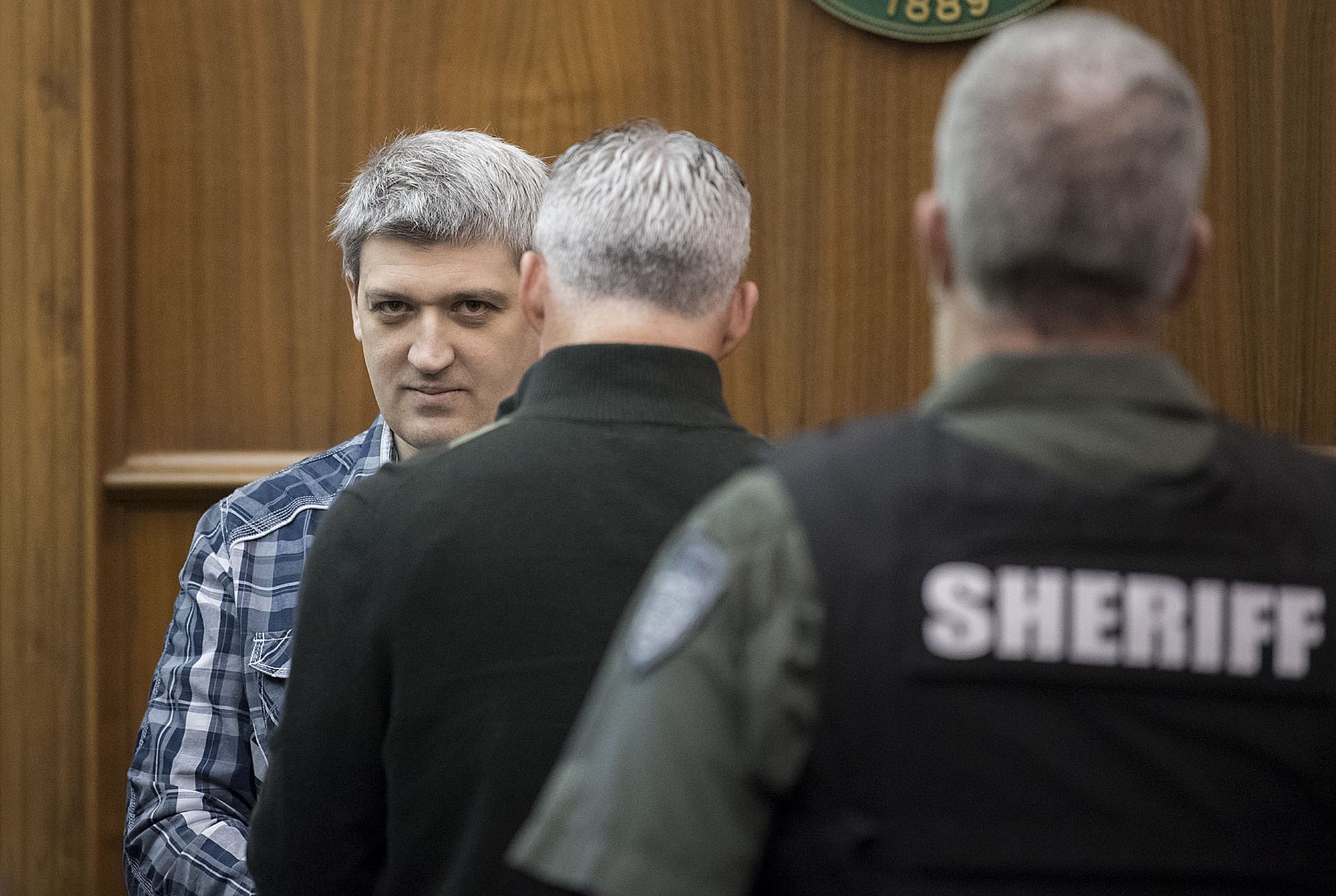 Brent Luyster prepares to be seated during his triple aggravated murder trial in Clark County Superior Court on Monday morning, Nov. 13, 2017.