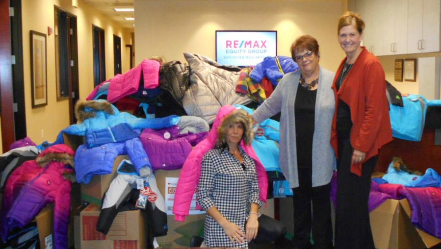 Vancouver Mall: Remax agents, from left, Pam Moore, Dominique Roark and Lori Anderson-Benson with the 200 coats collected for Open House Ministries, 50 of which were new coats purchased by Anderson-Benson.