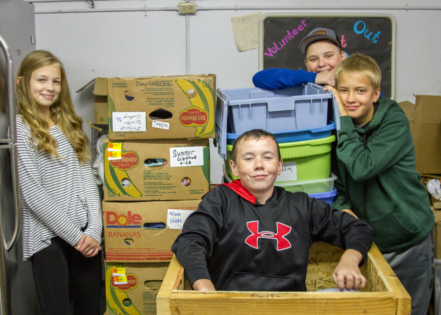 Woodland: Woodland Middle School seventh-graders, from left, Dasha Vasilenko, Blake Smith, Tyson Lindberg and Ian Peterson processing donations and restocking shelves at the Woodland Action Center as part of a volunteering project through their leadership class.