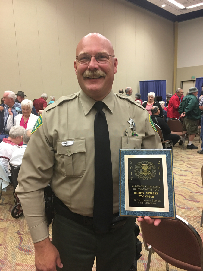 Clark County sheriff’s Deputy Tim Gosch and his award from the Washington State Grange organization honoring him as its Policeman of the Year in late June.