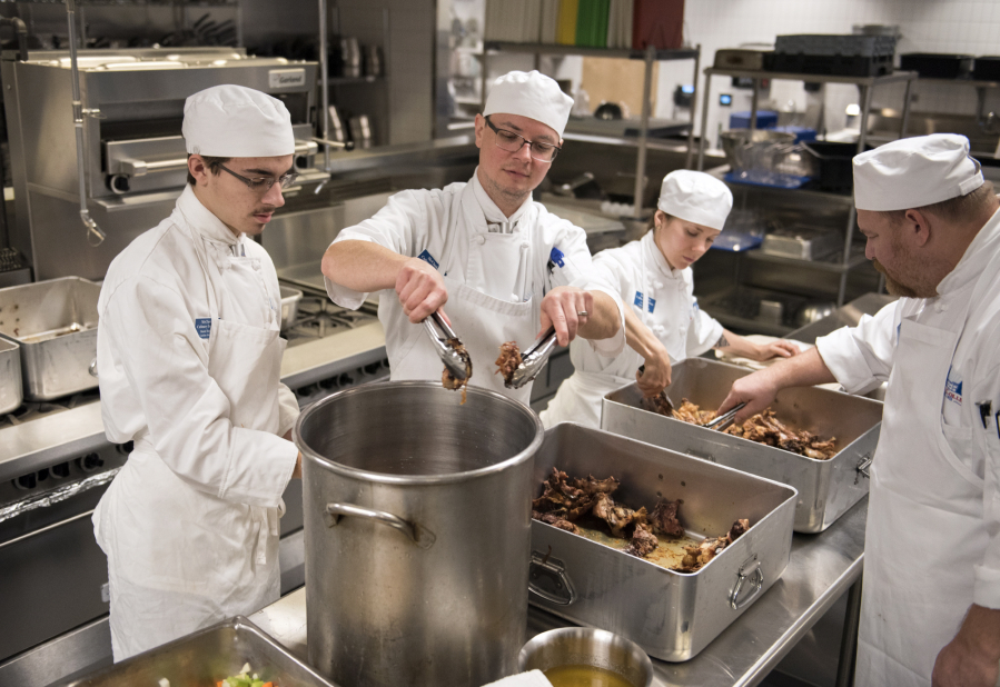 Culinary students Daniel Templin of Woodland, left, Aaron Welton of Battle Ground, Arryn Sayer of Castle Rock, and William Hobson of Vancouver, prepare chicken stock during their morning class at Clark College’s Tod and Maxine McClaskey Culinary Institute in Vancouver on Tuesday.