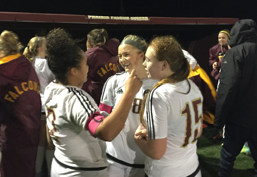 Prairie soccer players, from left, Malaika Quigley, Kaylin Sperley and Sydney Weber celebrate a 2-1 win over Marysville-Getchell in the Class 3A state playoffs on Wednesday in Brush Prairie.