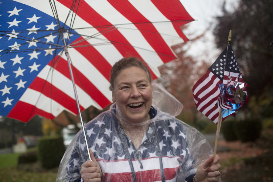 Lori Homola is decked out in American flags as she watches the Veterans Parade at Fort Vancouver on Nov. 5, 2016.