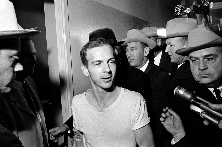 Gunman Lee Harvey Oswald talks to the media Nov. 23, 1963, at the Dallas police station as he is taken for questioning in connection with the JFK assassination.