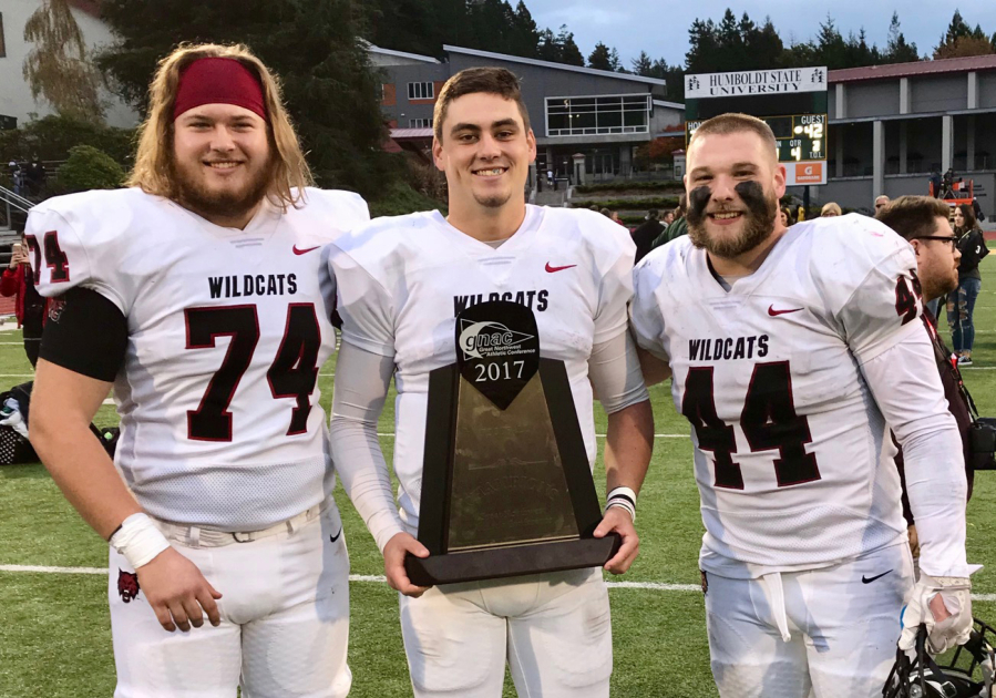 Central Washington's Clark County football players Will Ortner (Hockinson HS), Reilly Hennessey (Camas), and Kevin Haynes (Battle Ground) with the GNAC trophy after the Wildcats beat Humboldt State 42-28 on Saturday, Nov. 11, 2017, at Arcata, Calif., to wrap up an 11-0 regular season.