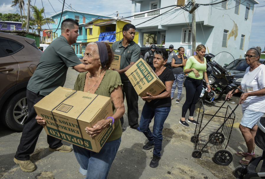 Hurricane Maria victims receive supplies and bottles of water from NYC Emergency Management Operations in the La Perla neighborhood in San Juan, Puerto Rico Nov. 10.