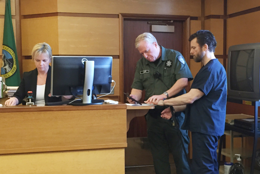 Clean energy entrepreneur John Garrett Smith is fingerprinted in Clark County Superior Court after being sentenced to 144 months in prison for the attempted murder of his wife. The Washington Supreme Court on Tuesday reversed an appeals court’s decision that had overturned Smith’s attempted murder conviction.