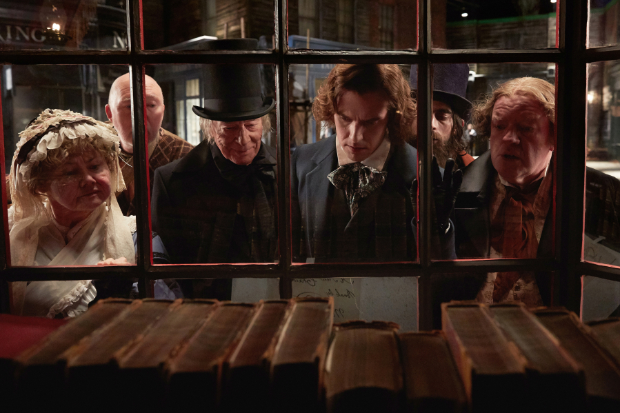Christopher Plummer, center left, stars as Ebenezer Scrooge and Dan Stevens, center right, stars as Charles Dickens in director Bharat Nalluri’s “The Man Who Invented Christmas,” which blends the famous tale with biographical details of author Dickens’ life.