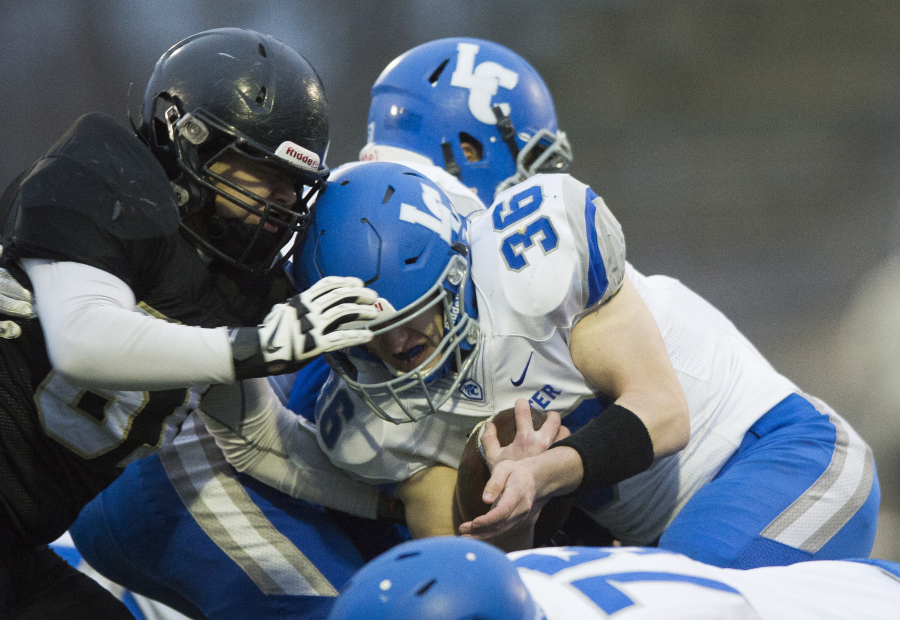 La Center’s Wyatt Dodson is tackled by Meridian’s Manny Sabalza on Saturday, Nov. 25, at Civic Stadium in Bellingham.